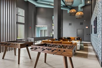 Gaming lounge with billiards, foosball, shuffleboard, and vintage arcade games